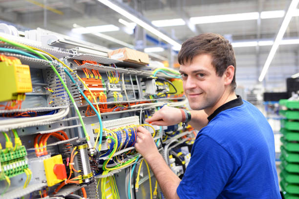 istock young operator assembles machine in a modern high tech factory - production of switch cabinets for industrial plant 1158397213