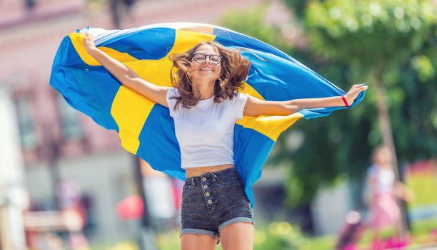 happy girl tourist går på gatan med sverige flaggan. - studenter sweden bildbanksfoton och bilder