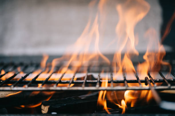 istock burning firewood with flame through bbq grill grates 1158402814