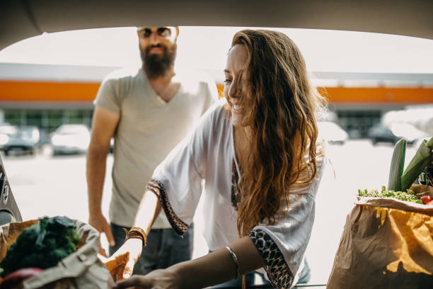 istock Young couple packing groceries 1158405921