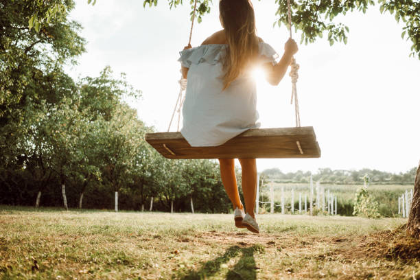 istock Beautiful woman enjoying on a swing 1158407278