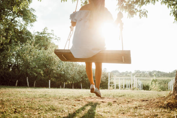istock Beautiful woman enjoying on a swing 1158407315