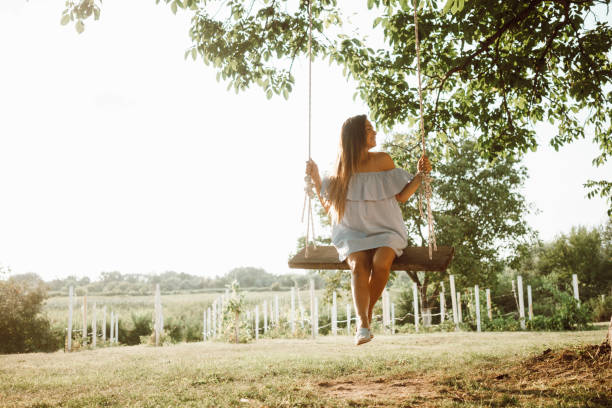 istock Beautiful woman enjoying on a swing 1158407516