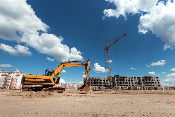 istock Excavator at a construction site against the background of a tower crane. Construction, technology 1158408840