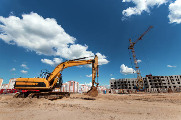 istock Excavator at a construction site against the background of a tower crane. Construction, technology 1158408843