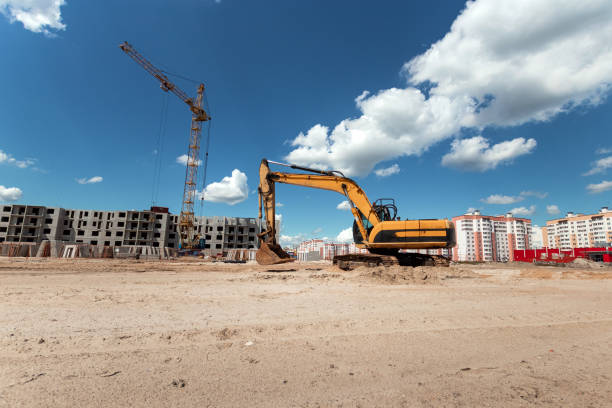 Excavator at a construction site against the background of a tower crane. Construction, technology stock photo