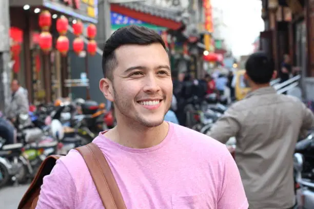 Photo of Cute man in crowded Asian street