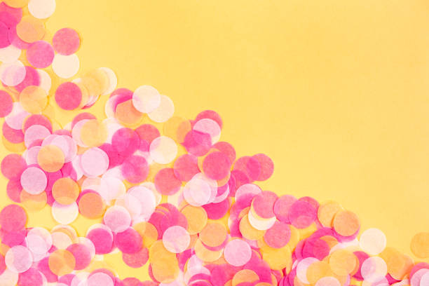 istock Orange, pink and white confetti on orange background. 1158413409