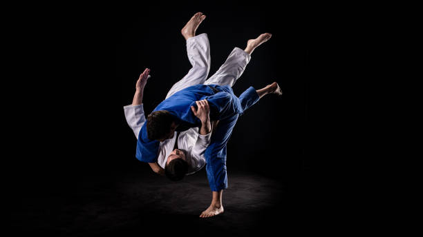 istock Judoka throwing his partner to the ground 1158421028