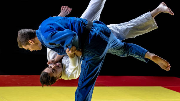 istock Judo practitioner throwing his partner to the ground 1158421135