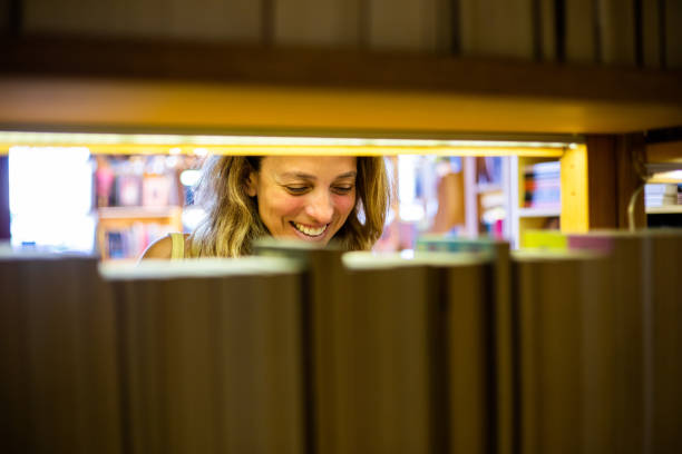 Woman searching for books in library