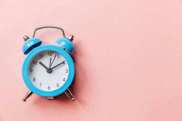 istock Vintage alarm clock Isolated on pink pastel background 1158423380