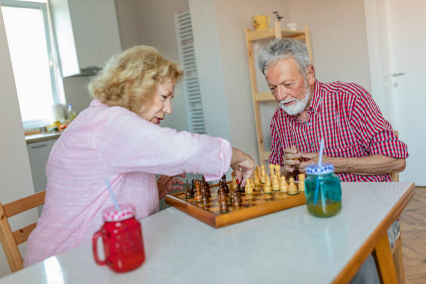 istock Senior couple playing chess at home 1158423467