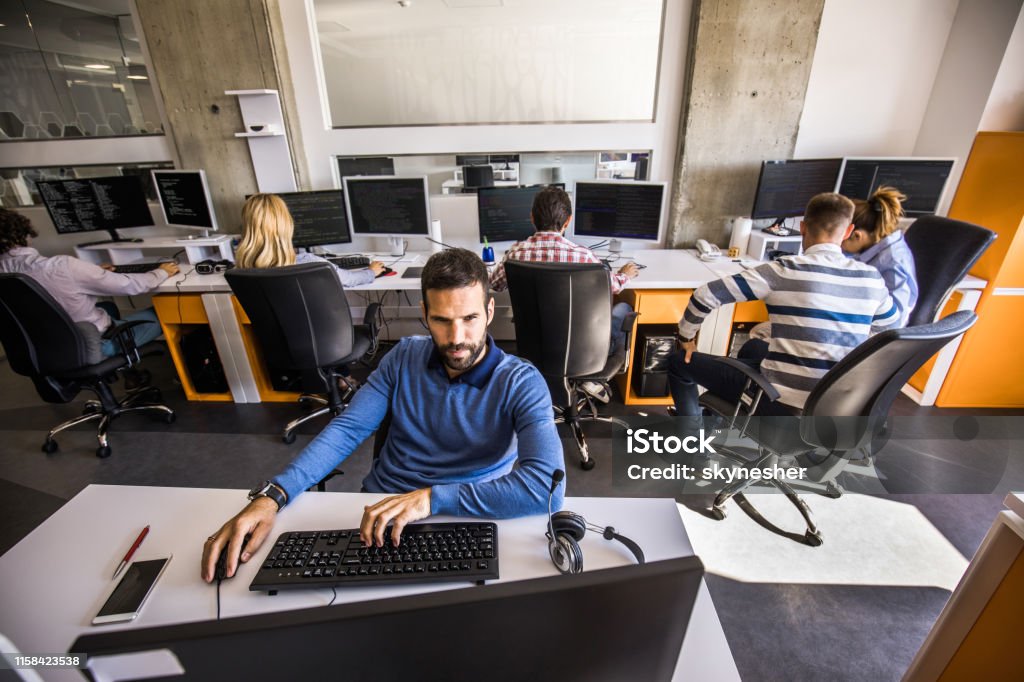 Working Environment For Computer Programer Young Computer Programmer Working On Pc In It Office Stock Photo ...