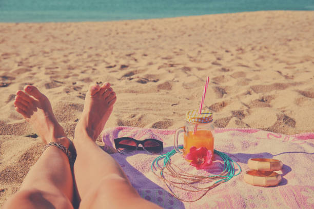 Woman lying down on the beach. Summer concept.