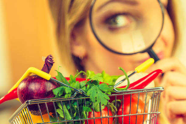 istock Woman investigating shopping backet with vegetables 1158424515