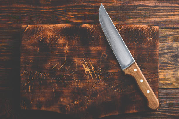 istock Knife over wooden cutting board 1158424682
