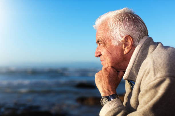 istock Thoughtful senior man looks out at the sea 1158424788