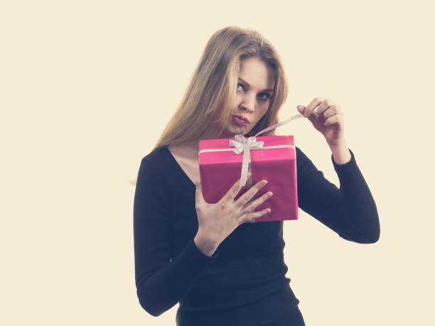 istock Girl opening pink gift box 1158424876