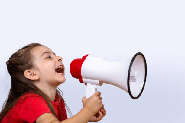 istock Little girl screaming on a megaphone. 1158431969