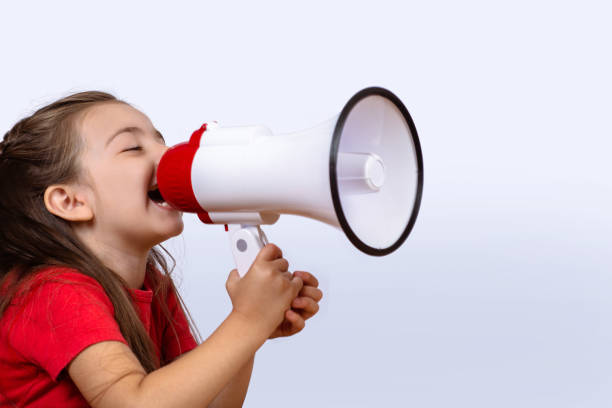 istock Little girl screaming on a megaphone. 1158431970