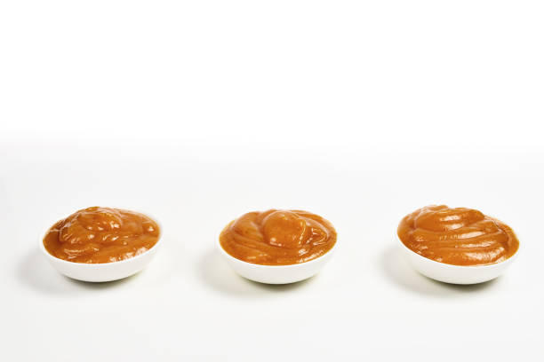 istock Orange sauce in white plate on white background. 1158435653