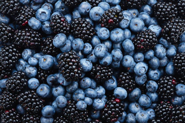 istock Blackberry and  blueberry background. Top view. 1158435655