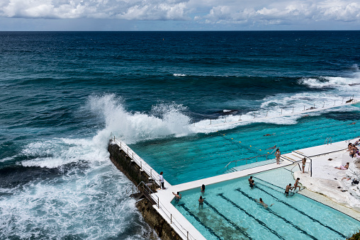 Bondi Beach, Australia - February 2, 2017: There is an outdoor swimming pool at the corner of the Bondi beach. It was made looked like a natural pool. It is also a famous place for tourists to visit.