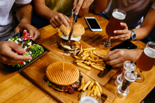 istock Cutting oversized burger in fast food restaurant 1158437331