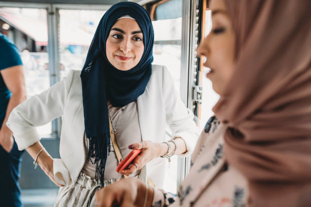 istock Friends talking together inside a bus in the city 1158438310
