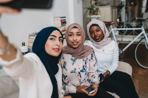 istock Three arab friends taking a selfie together at home 1158438321