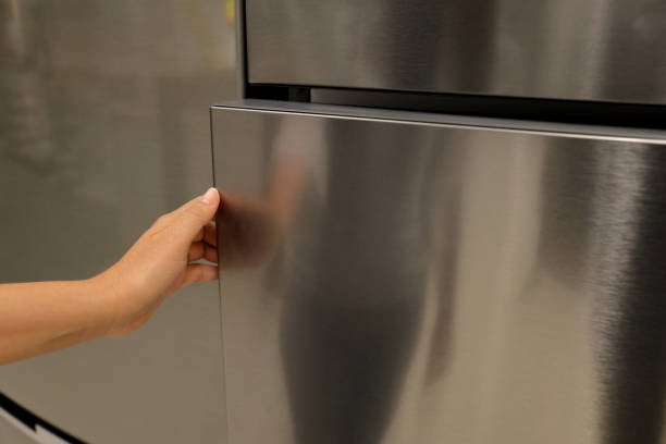 istock A hand is opening a refrigerator door 1158438626