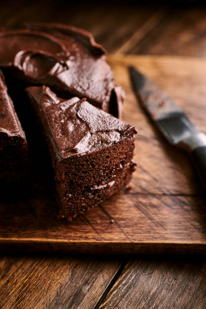 istock Sliced indulgent Chocolate cake against a rustic aged wooden surface. 1158444055