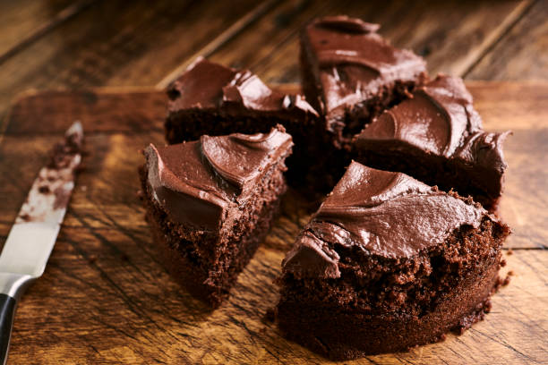 istock Sliced Chocolate cake against a aged rustic wooden background. 1158444060