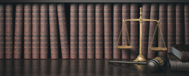 Low key filter law bookshelf with wooden judge's gavel and golden scale, 3D Rendering stock photo