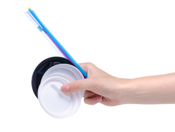 istock plastic lids and tubes for coffee cup in hand 1158449622
