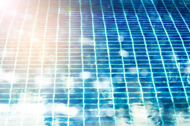 Light blue water surface shimmering with reflections and caustics, creating an abstract pattern that evokes a sense of tranquility and summer bliss