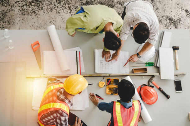 istock top view of group of engineer, technician and architect planning about building plan with blueprint and construction tools on the conference table at construction site, contractor and teamwork concept 1158453487