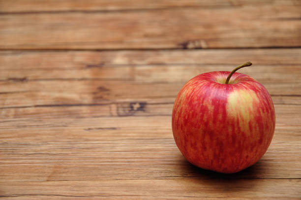 istock A red apple on a wooden background 1158454199