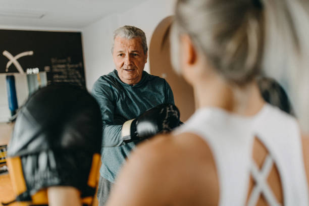 istock Senior man exercising with his personal trainer 1158455904