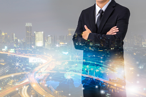 Double exposure of businessman with cityscape and globalization network, Business innovation and technology concept