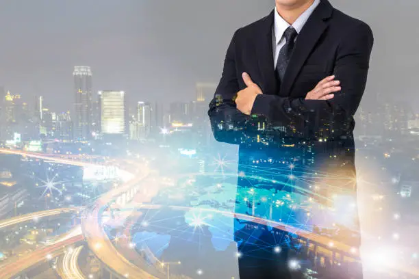 Photo of Double exposure of businessman with cityscape and globalization network, Business technology concept