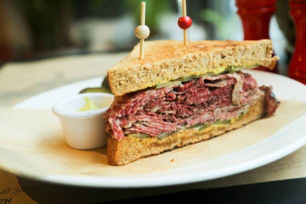 Pastrami sandwich Pastrami on rye sandwich with mustard and red wine pastrami stock pictures, royalty-free photos & images