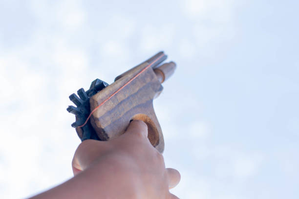 a boy is playing his game with fake gun