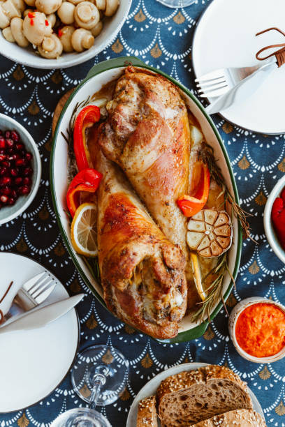istock Festive dish for Thanksgiving, roasted turkey legs with vegetables on a table with snacks. 1158459911