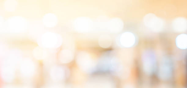 abstract blurred inside interior of luxury hotel with light bokeh bulbs background for design concept