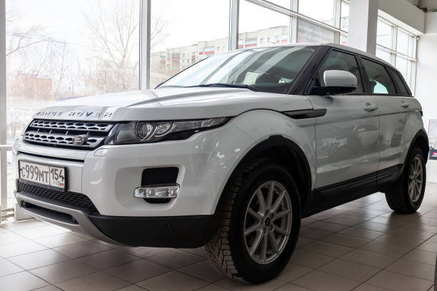 Front view of Range Rover Land Rover Evoque in white color after cleaning before sale in a dealership on parking Novosibirsk, Russia - 08.01.2018: Front view of Range Rover Land Rover Evoque in white color after cleaning before sale in a dealership on parking evoque stock pictures, royalty-free photos & images