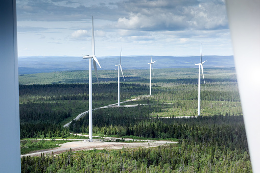 View on wind farm in north Sweden from high wind turbine with lakes and forest around