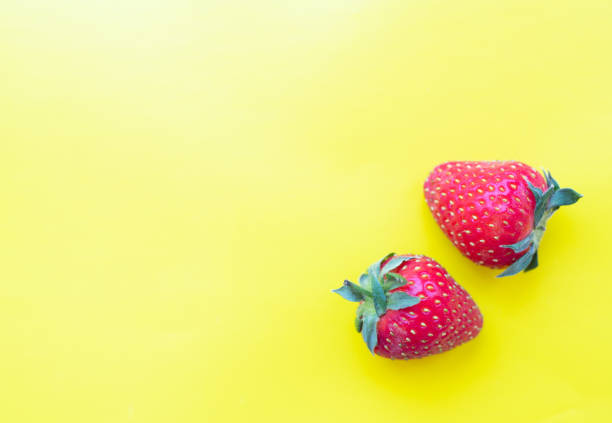 istock strawberries on a bright yellow background 1158465356