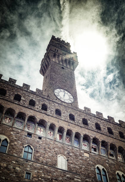 Bell tower of Palazzo Vecchio in the heart of Florence Italy The tower of Palazzo Vecchio, Florence, Italy on stunning dark cloudy sky palazzo vecchio stock pictures, royalty-free photos & images